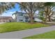 Charming two-story home with a landscaped yard and large trees at 16013 Eagle River Way, Tampa, FL 33624