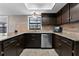 Kitchen with dark wood cabinets and granite counters at 16013 Eagle River Way, Tampa, FL 33624