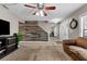 Living room featuring a wood accent wall and fireplace at 16013 Eagle River Way, Tampa, FL 33624