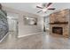 Living room with a stone fireplace and wood-look wall at 16013 Eagle River Way, Tampa, FL 33624