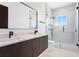Modern bathroom with double vanity, marble countertop, and glass shower at 17059 Dolphin Dr, North Redington Beach, FL 33708