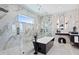 Modern bathroom with a glass enclosed shower and marble walls at 17059 Dolphin Dr, North Redington Beach, FL 33708