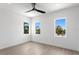 Spacious bedroom with wood-look flooring and three windows at 17059 Dolphin Dr, North Redington Beach, FL 33708