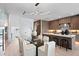 Modern dining area with glass table and white chairs, near kitchen at 17059 Dolphin Dr, North Redington Beach, FL 33708