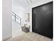 Modern entryway with staircase, light wood floors, and a statement door at 17059 Dolphin Dr, North Redington Beach, FL 33708