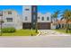 Modern home with a three-car garage and landscaped yard at 17059 Dolphin Dr, North Redington Beach, FL 33708