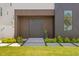 Stylish front entrance with a modern dark brown door and landscaping at 17059 Dolphin Dr, North Redington Beach, FL 33708