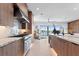 Modern kitchen features stainless steel appliances and marble countertops, overlooking a waterfront view at 17059 Dolphin Dr, North Redington Beach, FL 33708