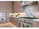Modern kitchen with wood cabinetry, marble countertops, and high-end appliances at 17059 Dolphin Dr, North Redington Beach, FL 33708