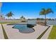 Freeform pool and spa with a mosaic tile design, steps leading to the water, and a grassy area at 17059 Dolphin Dr, North Redington Beach, FL 33708