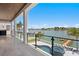 Spacious waterfront patio with glass railings and amazing water views at 17059 Dolphin Dr, North Redington Beach, FL 33708