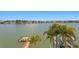 Scenic waterfront view with private dock and lush tropical foliage at 17059 Dolphin Dr, North Redington Beach, FL 33708