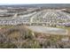 Aerial view of neighborhood with houses and lake at 18079 Ramble On Way, Land O Lakes, FL 34638