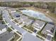 Aerial view of neighborhood with houses and lake at 18079 Ramble On Way, Land O Lakes, FL 34638