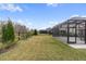 Screened patio and grassy backyard with privacy fence at 18079 Ramble On Way, Land O Lakes, FL 34638