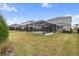 Large backyard with screened patio and grassy area at 18079 Ramble On Way, Land O Lakes, FL 34638