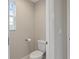 Small bathroom with toilet and window at 18079 Ramble On Way, Land O Lakes, FL 34638