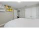 Bright bedroom with white bedding and built-in shelves at 18079 Ramble On Way, Land O Lakes, FL 34638