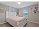 Cozy bedroom with white bed frame and colorful decor at 18079 Ramble On Way, Land O Lakes, FL 34638