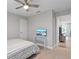 Main bedroom with queen bed, TV stand, and access to another room at 18079 Ramble On Way, Land O Lakes, FL 34638