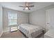 Cozy bedroom with a queen-size bed, nightstand, and ceiling fan at 18079 Ramble On Way, Land O Lakes, FL 34638