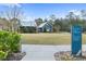 Community area with a grassy lawn and building at 18079 Ramble On Way, Land O Lakes, FL 34638