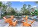 Orange Adirondack chairs around a fire pit in a community space at 18079 Ramble On Way, Land O Lakes, FL 34638