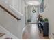 Elegant foyer with hardwood floors, piano, and access to the front door at 18079 Ramble On Way, Land O Lakes, FL 34638