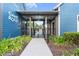 Entrance to a community game room with a gate and landscaping at 18079 Ramble On Way, Land O Lakes, FL 34638