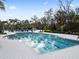 Community lap pool surrounded by lounge chairs at 18079 Ramble On Way, Land O Lakes, FL 34638