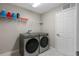 Laundry room with washer, dryer, and shelving at 18079 Ramble On Way, Land O Lakes, FL 34638