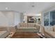 Spacious living room with leather sofas and view into kitchen at 18079 Ramble On Way, Land O Lakes, FL 34638
