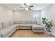 Spacious living room featuring a large sectional sofa and wood-look floors at 18079 Ramble On Way, Land O Lakes, FL 34638
