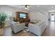 Living room with light leather sofas and large entertainment center at 18079 Ramble On Way, Land O Lakes, FL 34638