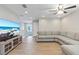 Bright living area with sectional sofa, large TV, and wood-look floors at 18079 Ramble On Way, Land O Lakes, FL 34638