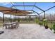 Covered patio with dining table and seating area at 18079 Ramble On Way, Land O Lakes, FL 34638