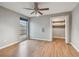 Bright bedroom with wood floors, ceiling fan, and spacious closet at 1824 Southwood Ln, Clearwater, FL 33764