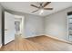 Light and airy bedroom with wood floors and access to another room at 1824 Southwood Ln, Clearwater, FL 33764