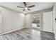Bedroom with wood-look floors, pool view, and ceiling fan at 1824 Southwood Ln, Clearwater, FL 33764