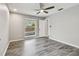 Bedroom with wood-look floors, pool view, and ceiling fan at 1824 Southwood Ln, Clearwater, FL 33764