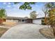 Mid-century modern home with a two-car garage and manicured lawn at 1824 Southwood Ln, Clearwater, FL 33764