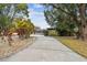 Landscaped front yard with a long driveway leading to the house at 1824 Southwood Ln, Clearwater, FL 33764