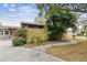 Home's exterior showcasing a walkway and landscaping at 1824 Southwood Ln, Clearwater, FL 33764