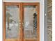 Double wood doors featuring etched bird design at 1824 Southwood Ln, Clearwater, FL 33764