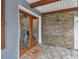 Double wood doors with etched glass and stone accent wall at 1824 Southwood Ln, Clearwater, FL 33764