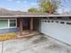House exterior with double doors and attached garage at 1824 Southwood Ln, Clearwater, FL 33764