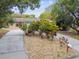 Landscaped front yard with a circular driveway at 1824 Southwood Ln, Clearwater, FL 33764