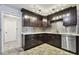 Modern kitchen with dark wood cabinets, granite countertops and stainless steel appliances at 1824 Southwood Ln, Clearwater, FL 33764