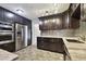 Updated kitchen, featuring dark cabinetry, granite countertops and stainless steel appliances at 1824 Southwood Ln, Clearwater, FL 33764