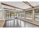 Spacious living area with hardwood floors, wood beams, and access to backyard at 1824 Southwood Ln, Clearwater, FL 33764